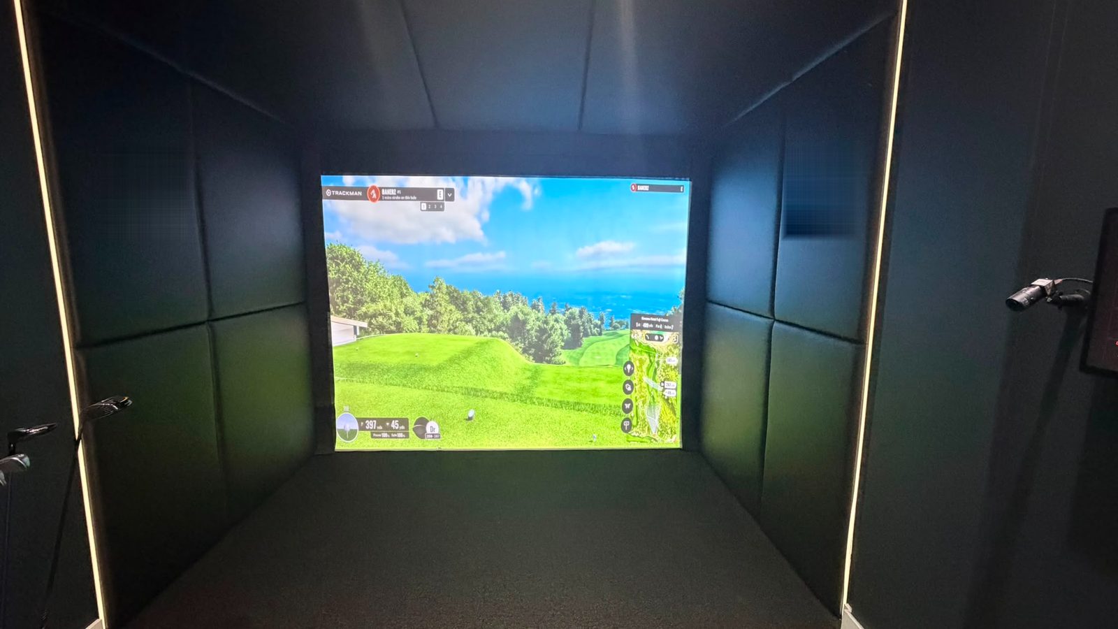 A Cheekygolf-branded simulator bay